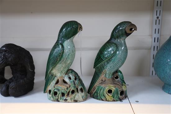 Two similar Chinese enamelled biscuit figures of parrots, Kangxi period, H. 21cm and 21.5cm